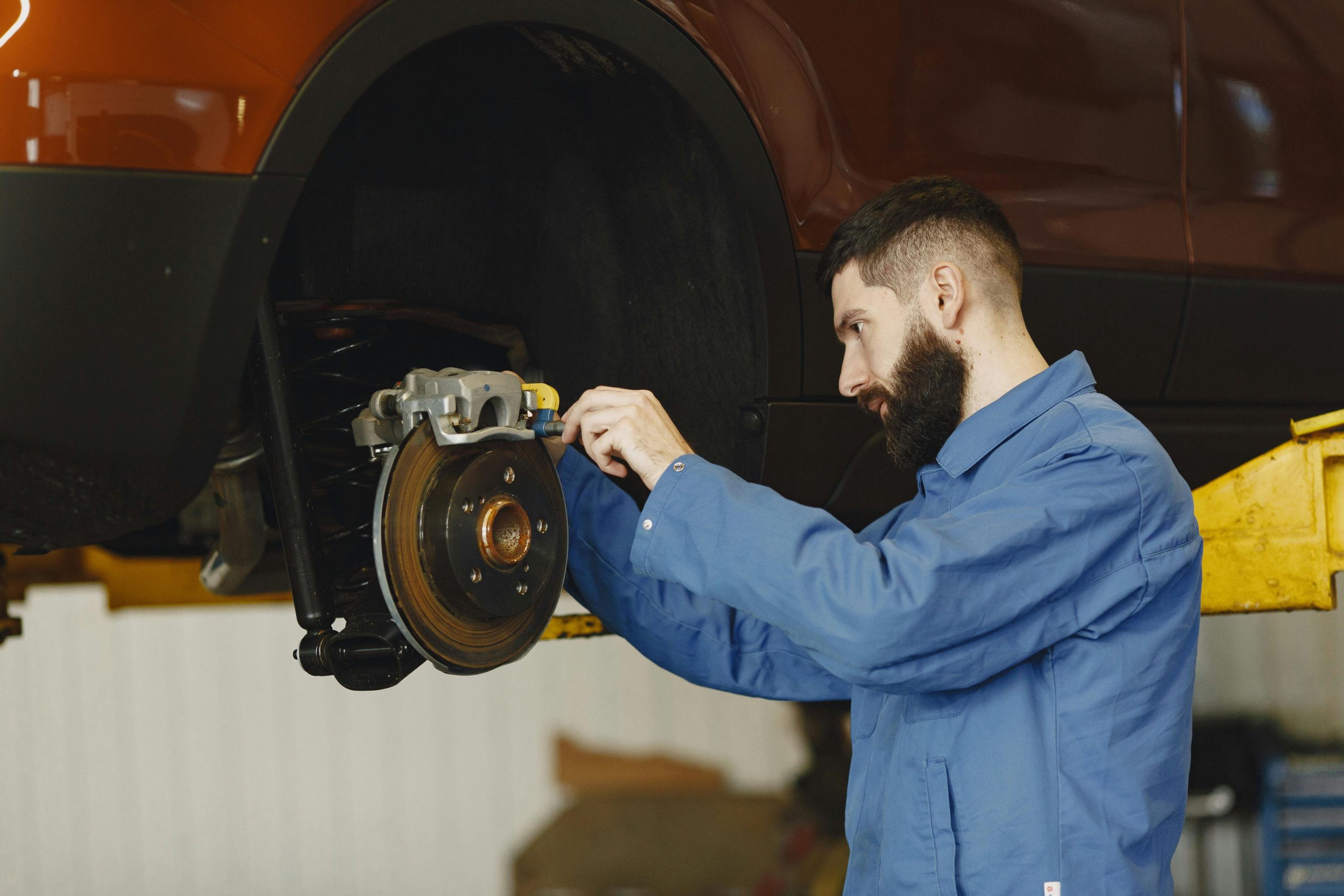 mechanic fixing a car's brake system